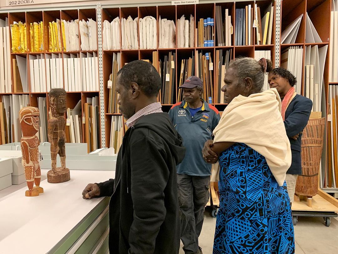 Pedro Wonaeamirri (left) inspecting the Art Gallery of NSW's historical Tiwi collection in 2023.