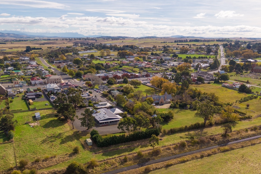 An aerial photo of a township surrounded by green paddocks