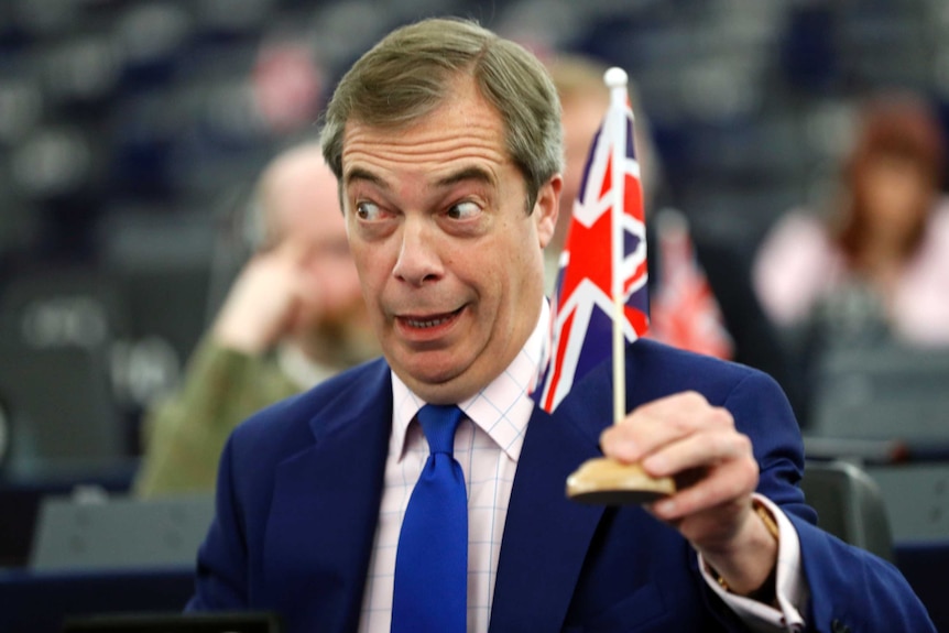 Nigel Farage holding a mini Union Jack flag