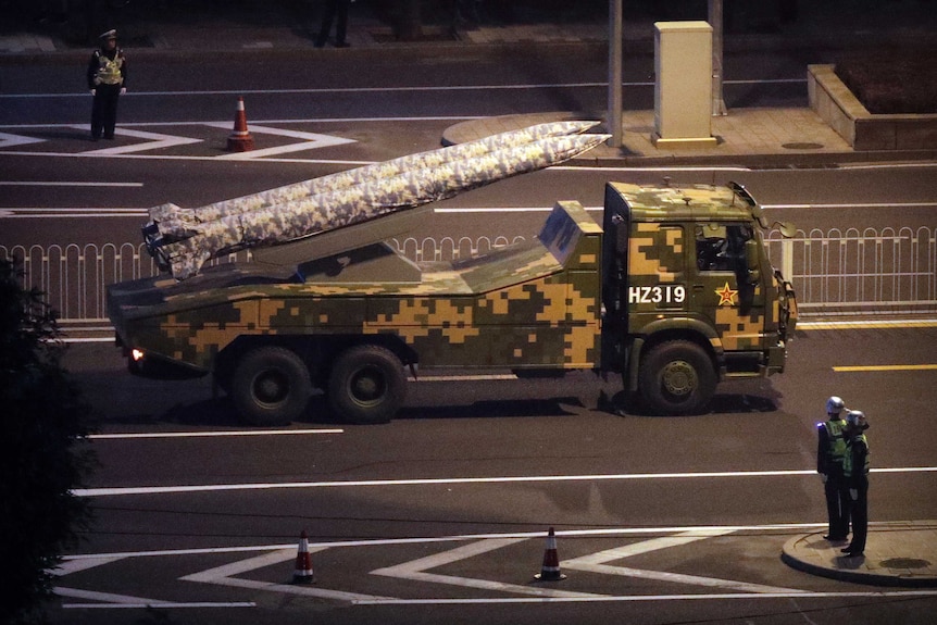 A military truck on carries two rockets on the streets of Beijing.