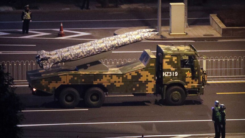 A military truck on carries two rockets on the streets of Beijing.