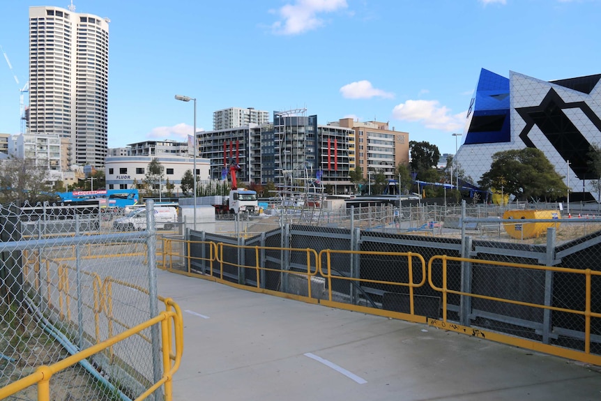 An empty space at the Perth City Link development near Perth Arena, with fences in the foreground of a work site.