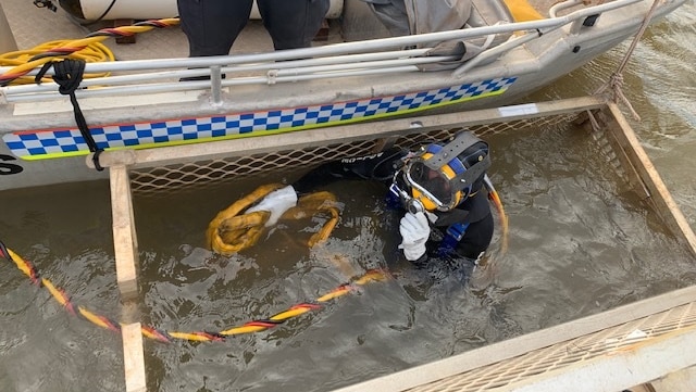 A police diver in a cage