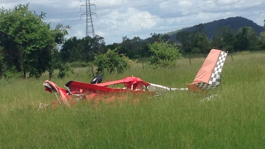 The wreckage of a red ultralight plane