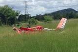 The wreckage of a red ultralight plane