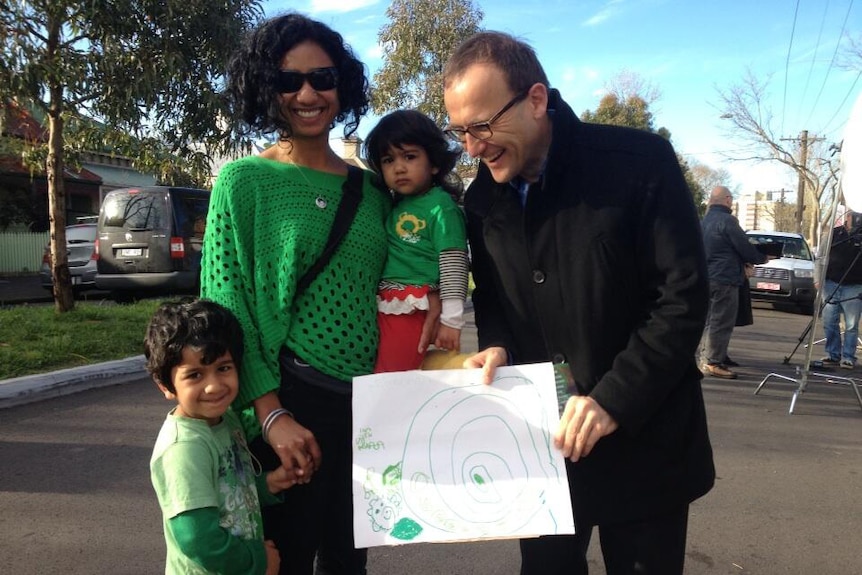 Adam Bandt meets a young supporter outside a polling booth in Melbourne