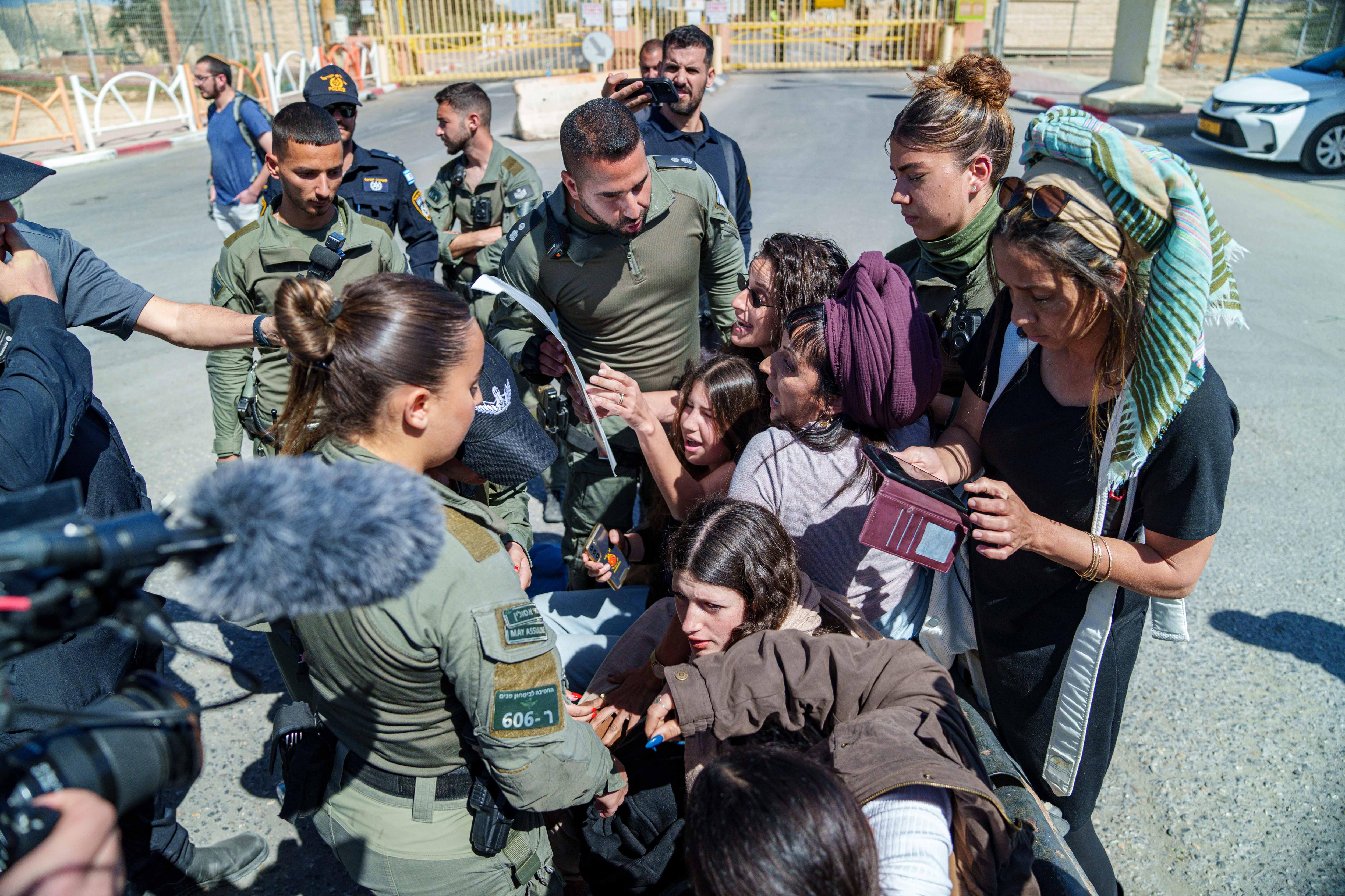 Police surround a group of girls. 