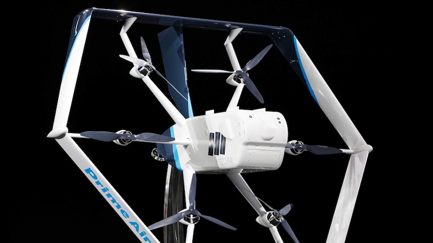 An up-close picture of Amazon's new drone, which is white for electric blue trim and has six propellers