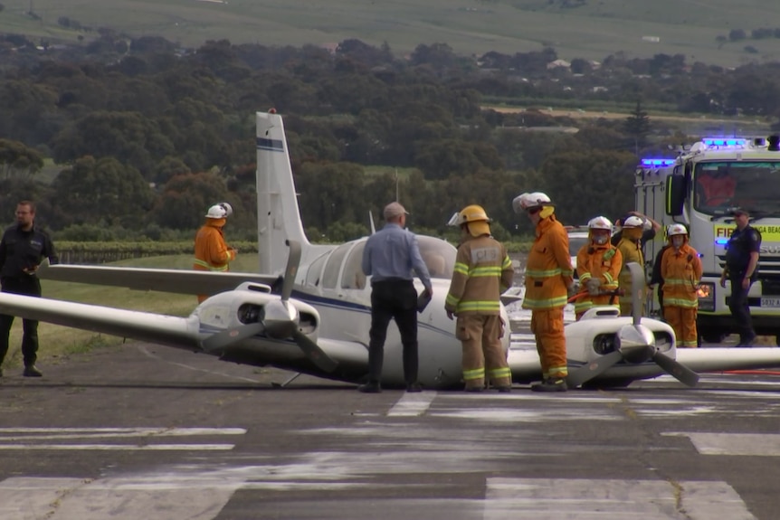 A plane landed with emergency service personal around it 