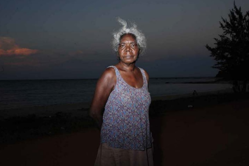 Yolngu elder Banduk Marika standing on a beach.