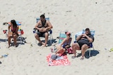 Governor Chris Christie and his family lounge around on a beach.