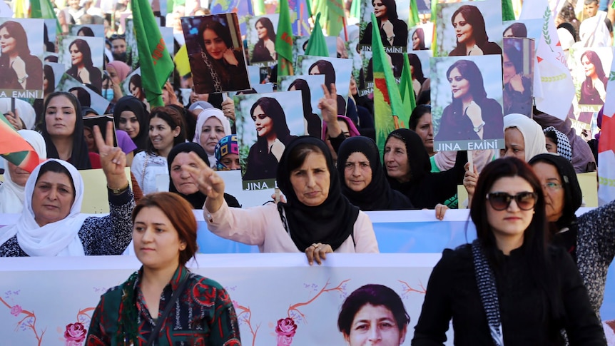 Women holding signs during a protest. 