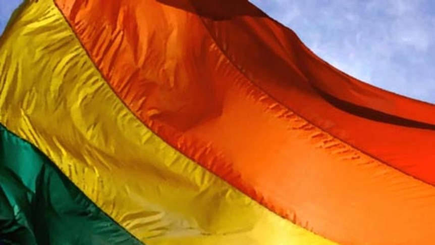 The sun shines through the gay pride/rainbow flag