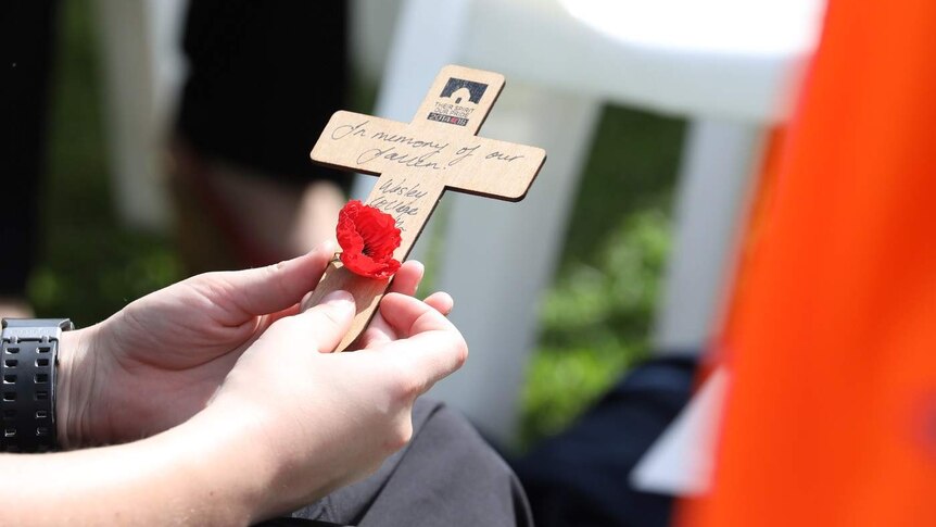 A cross with a poppy attached.