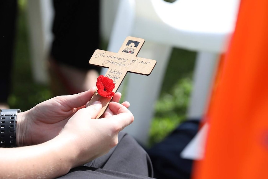 A cross with a poppy attached.