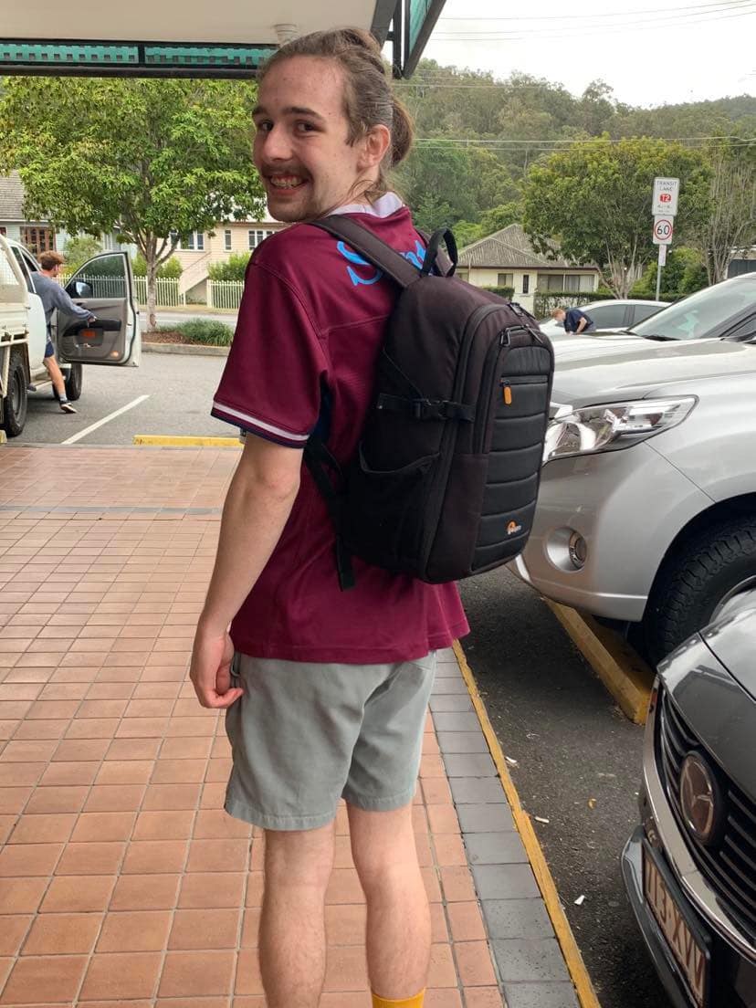 Sam Mooney wears his new backpack, carrying the photography equipment