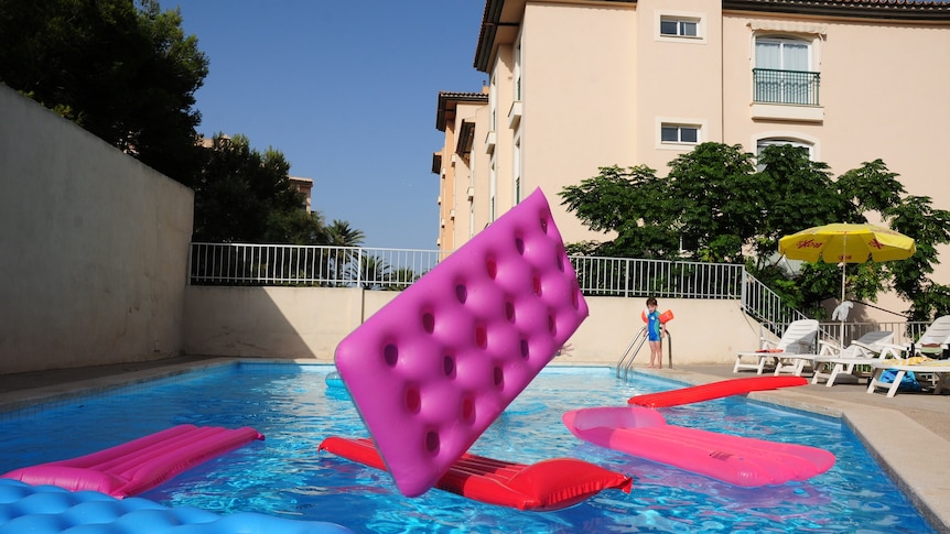 Swimming pool with pink floating toys