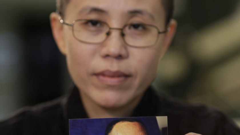 Liu Xia holds a photo of Liu Xiaobo