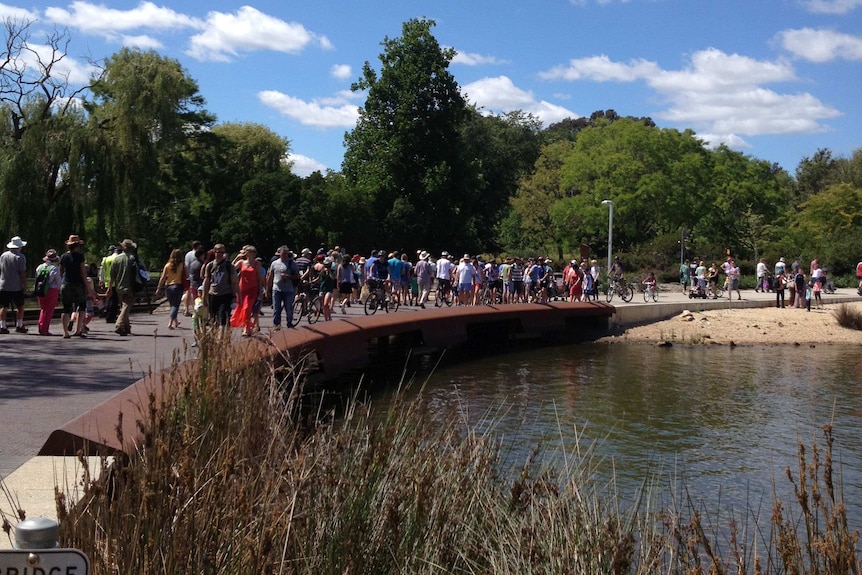 Crowds on the move around Lake Burley Griffin for Canberra's centenary celebrations.