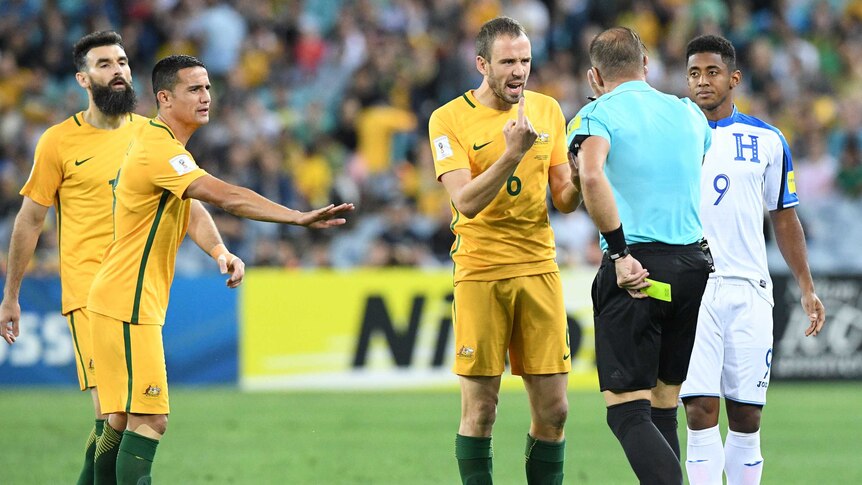 Socceroos' Matt Jurman gets a yellow card against Honduras