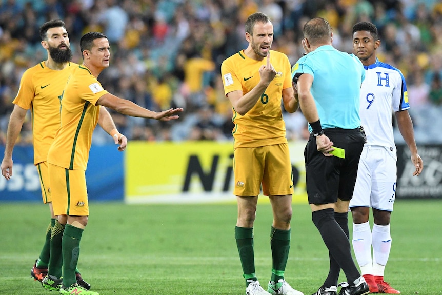 Socceroos' Matt Jurman gets a yellow card against Honduras