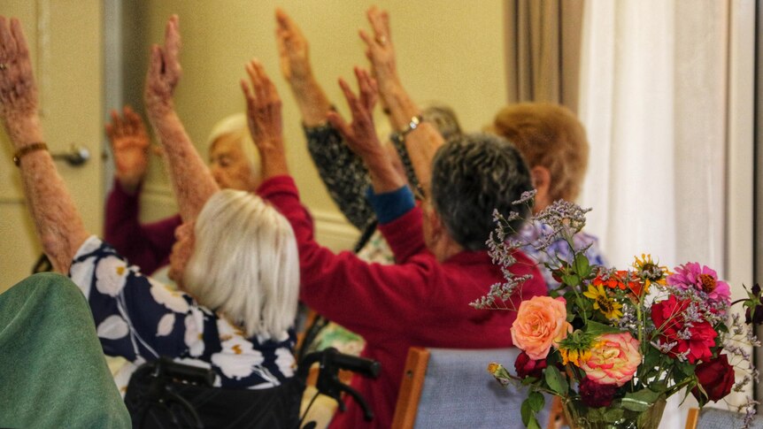 Aged care residents with arms in the air