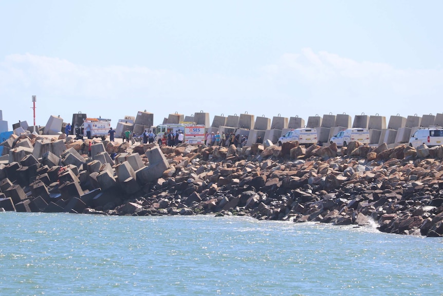 Police cars line the breakwall