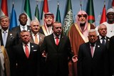 Turkey's President Recep Tayyip Erdogan, centre, flanked by Jordan's King Abdullah II, left