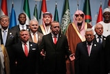 Turkey's President Recep Tayyip Erdogan, centre, flanked by Jordan's King Abdullah II, left