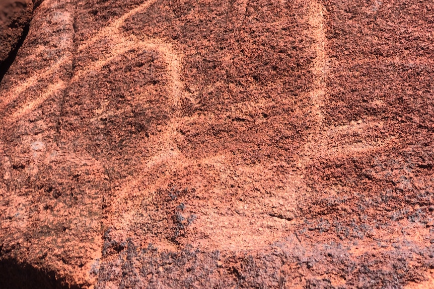 An ancient rock carving depicting an animal.