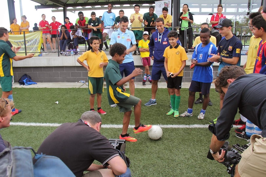 A young boy shows off his skills at a Football United event.