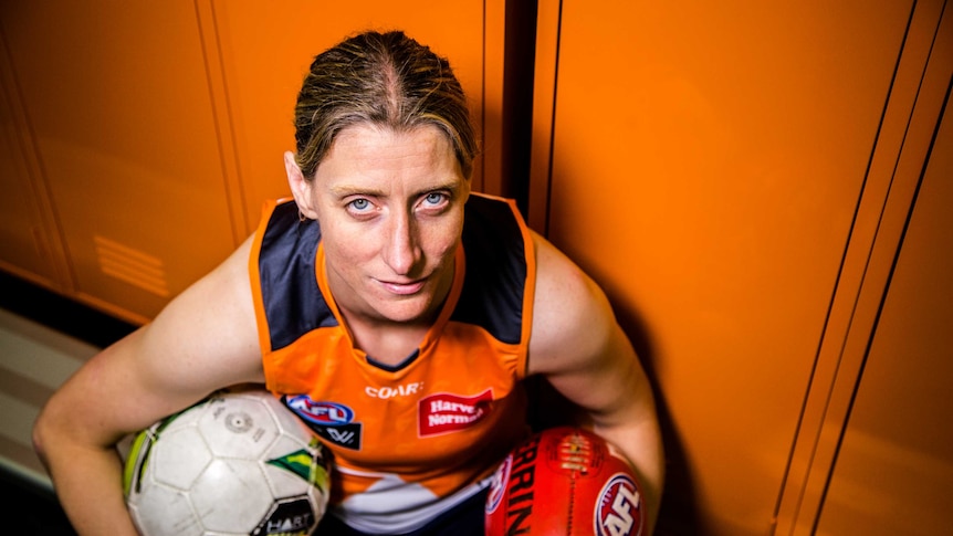 Irish AFLW star Cora Staunton poses with balls from the two codes she has excelled in.
