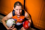 Irish AFLW star Cora Staunton poses with balls from the two codes she has excelled in.