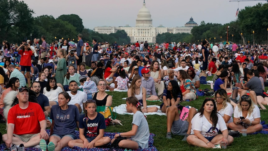 People gather for the annual Independence Day fireworks celebration at the National Mal