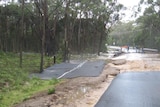 The tarmac washed away from the Tasman Highway during flooding at St Helens on Tasmania's east coast