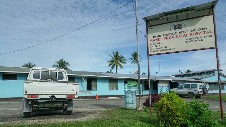 A bright blue building and a sign reading "Manus Provincial Hospital"