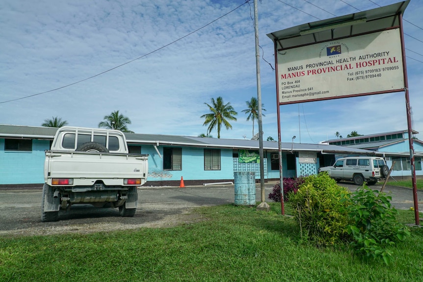 A bright blue building and a sign reading "Manus Provincial Hospital"