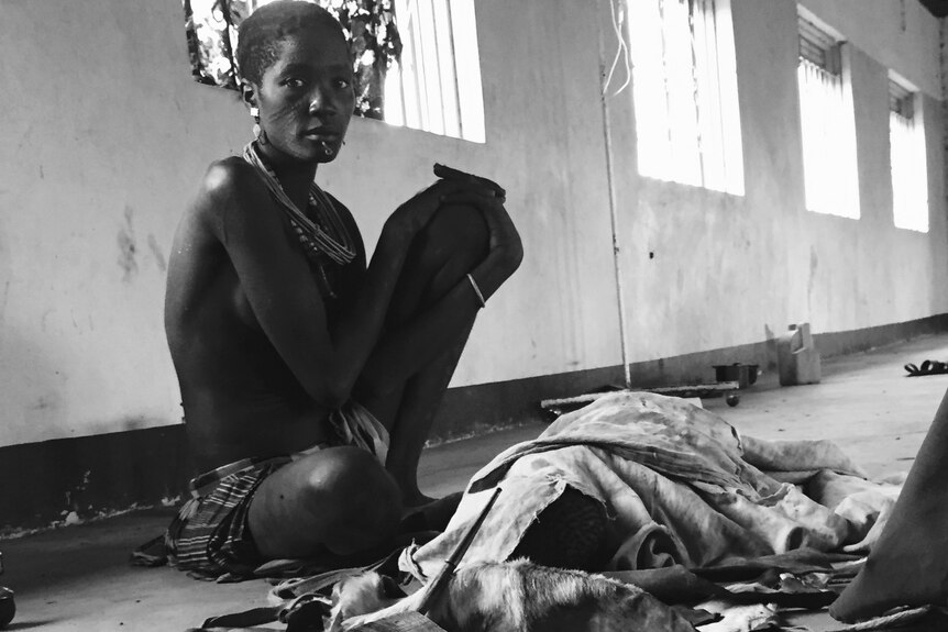 Mother of two-year-old boy, Lokai Lopuke, waits for cholera test results.