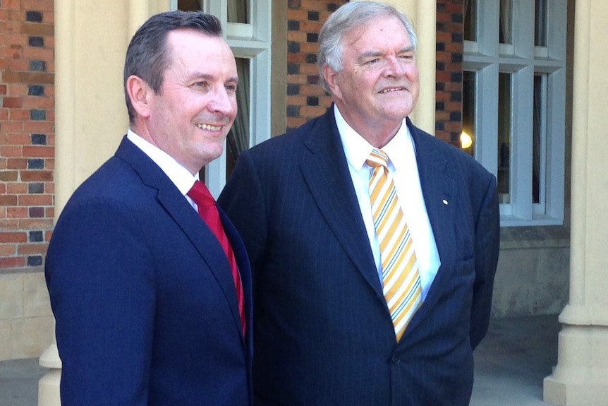 Premier Mark McGowan and former Labor leader Kim Beazley stand side by side shaking hands.