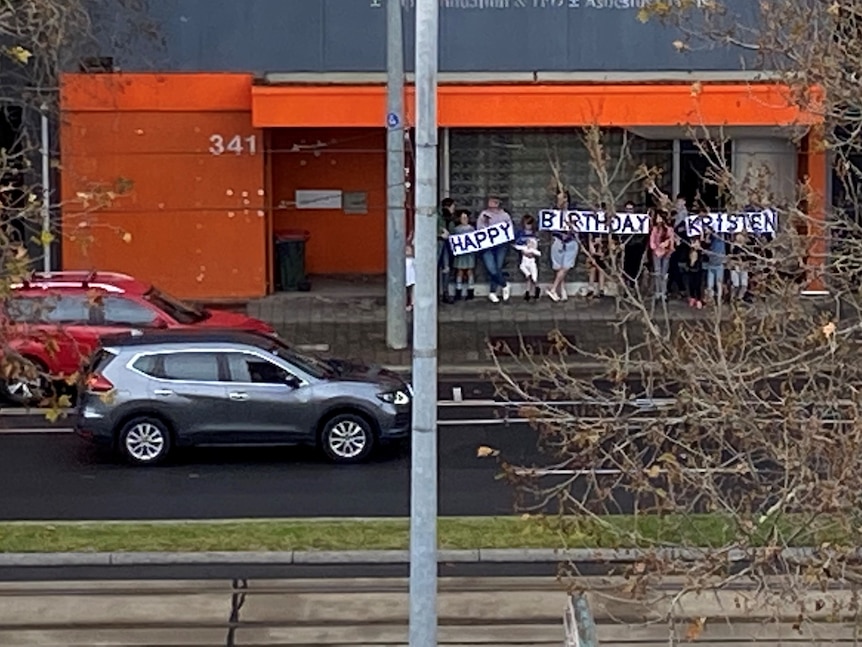 People holding signs on a city street