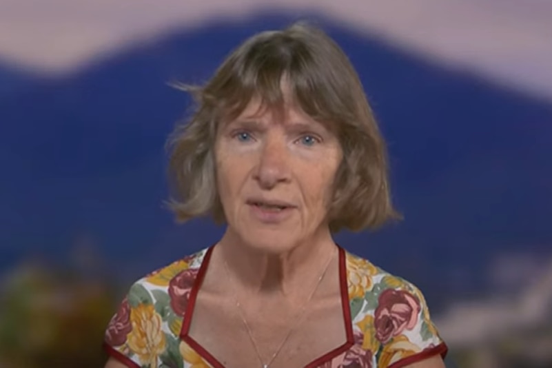 a woman in frame for a abc news interview 