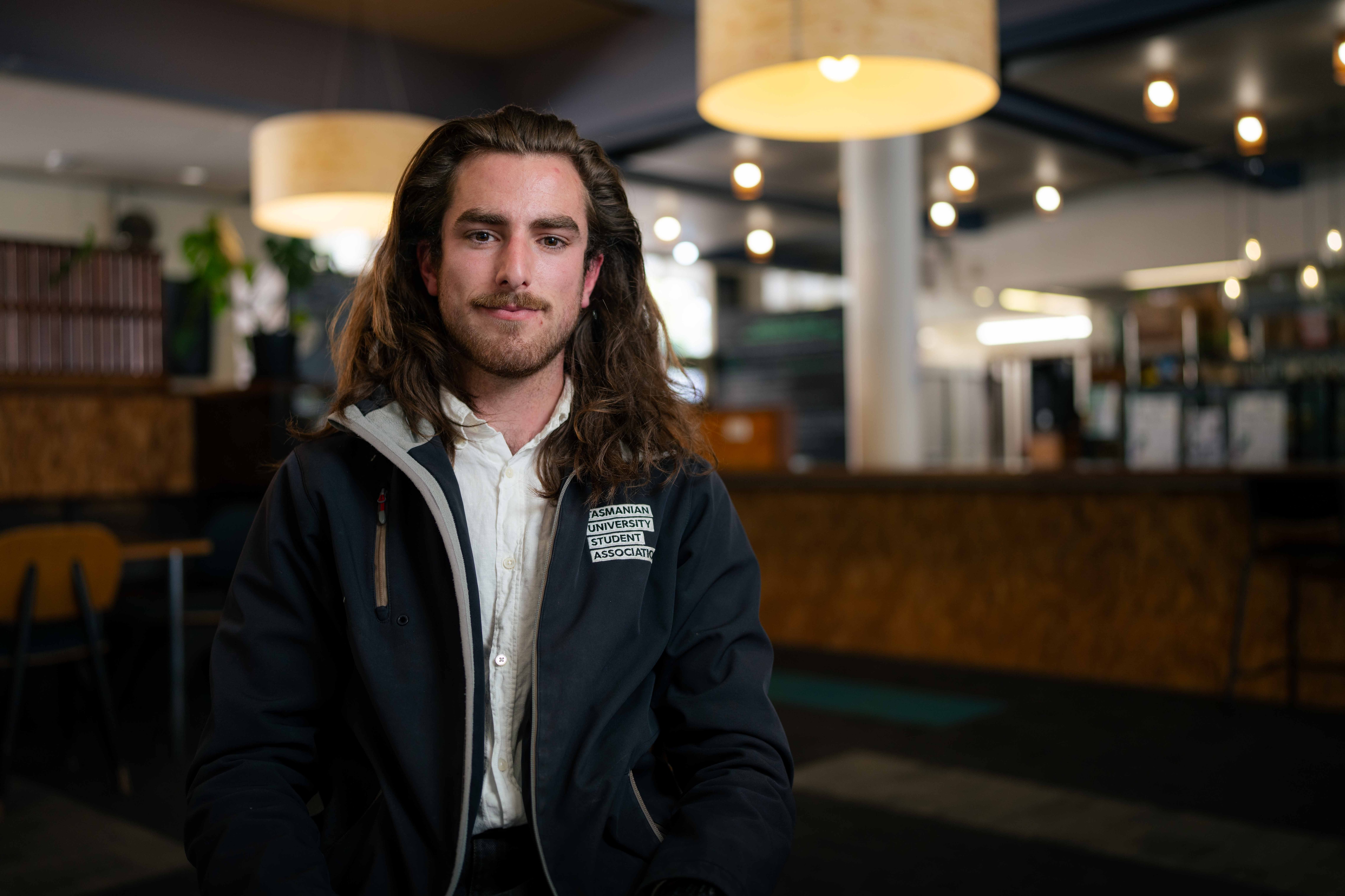 Person sitting on chair smiling for photo