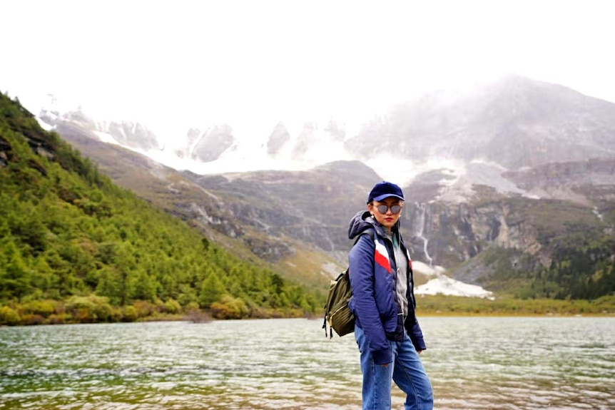 A woman standing near a river