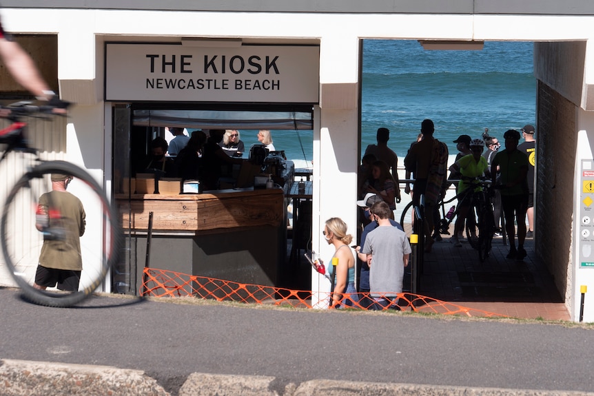 People queuing at a beach side kiosk