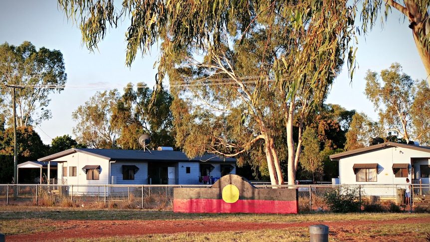 A park area at sunset with an Aboriginal flag mural