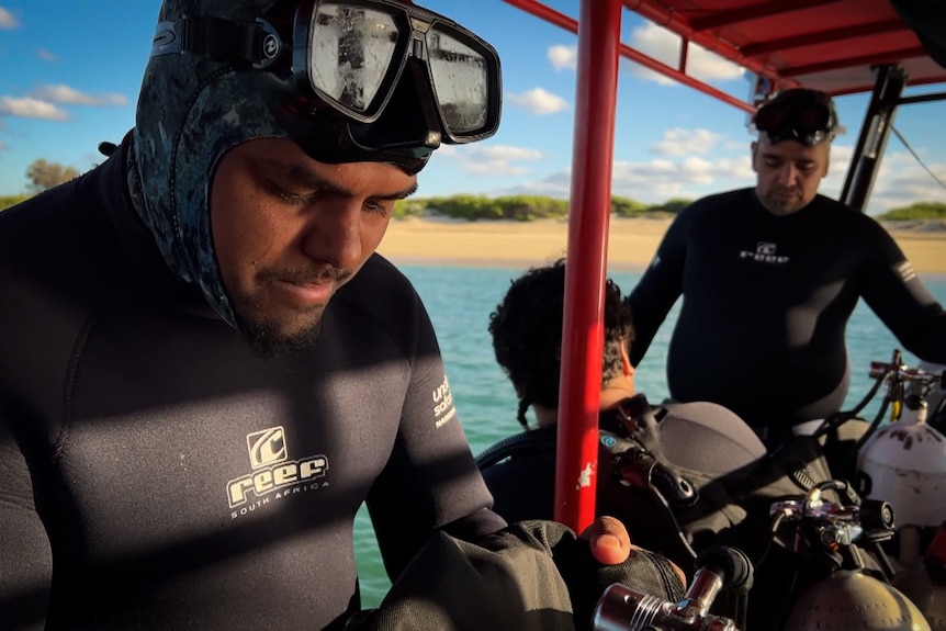 Close-up of man in diving gear preparing to dive