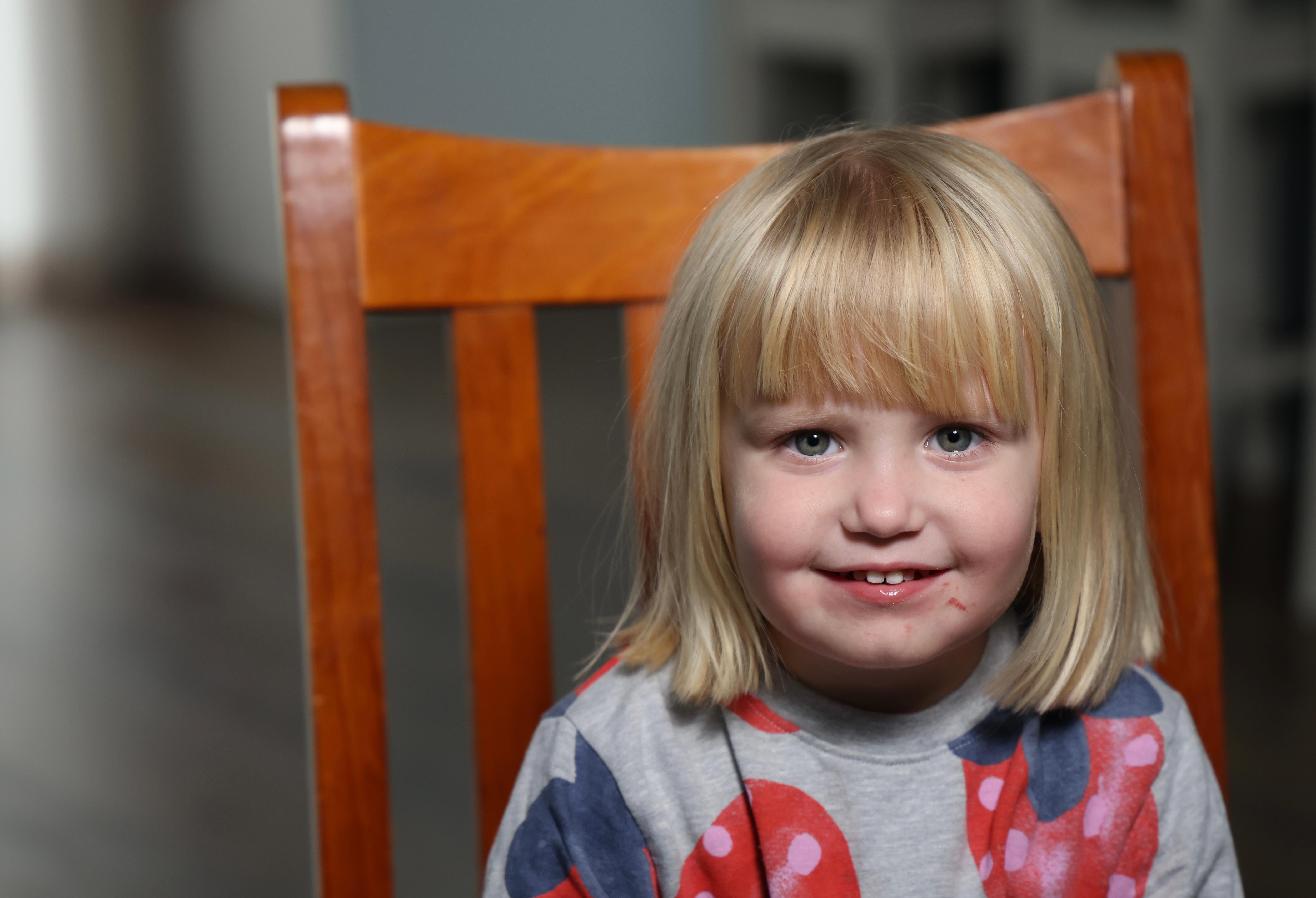 a little blonde girl smiling into the camera