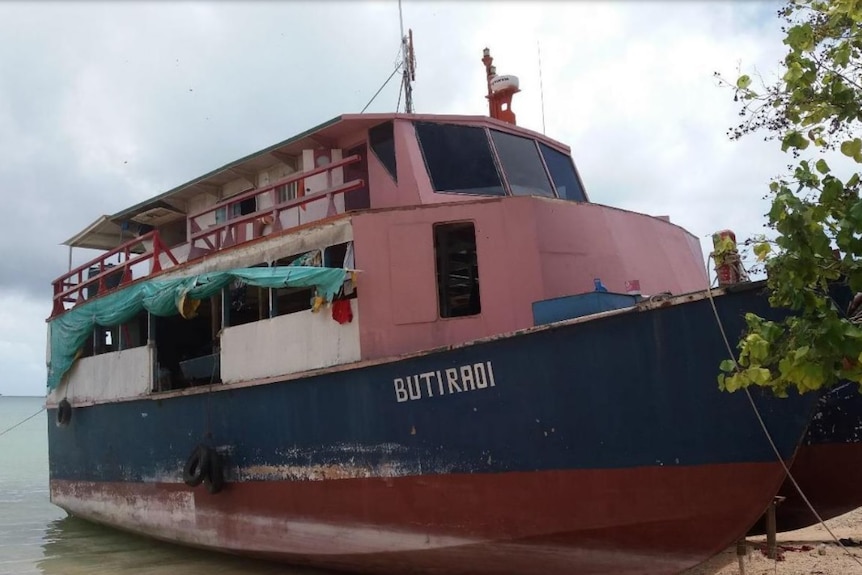 The ferry MV Butiraoi sits on the edge of a beach, in this image taken before the accident.