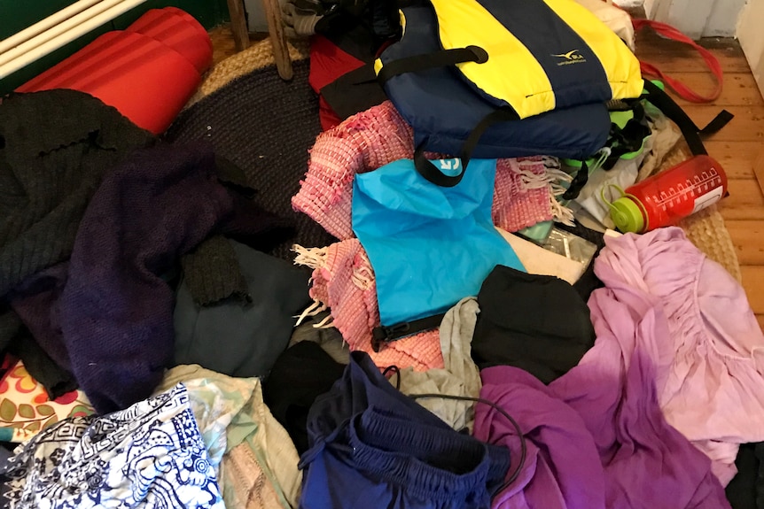 Photograph of a pile of messy clothes.