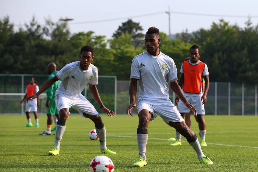 Young Vanuatu footballers keep their eyes fixed to the ball during a training session.